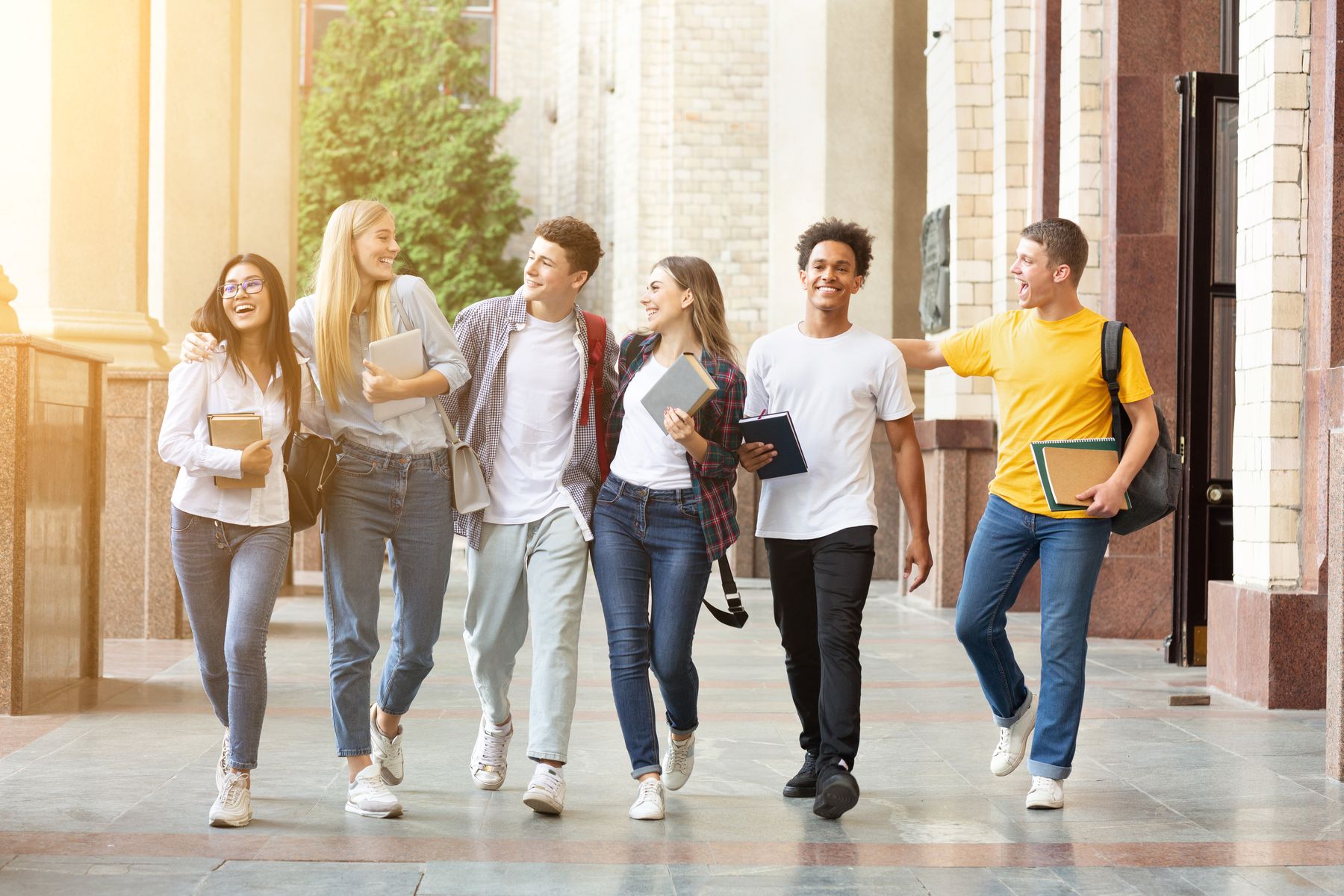 Students laughing as they walk together across campus