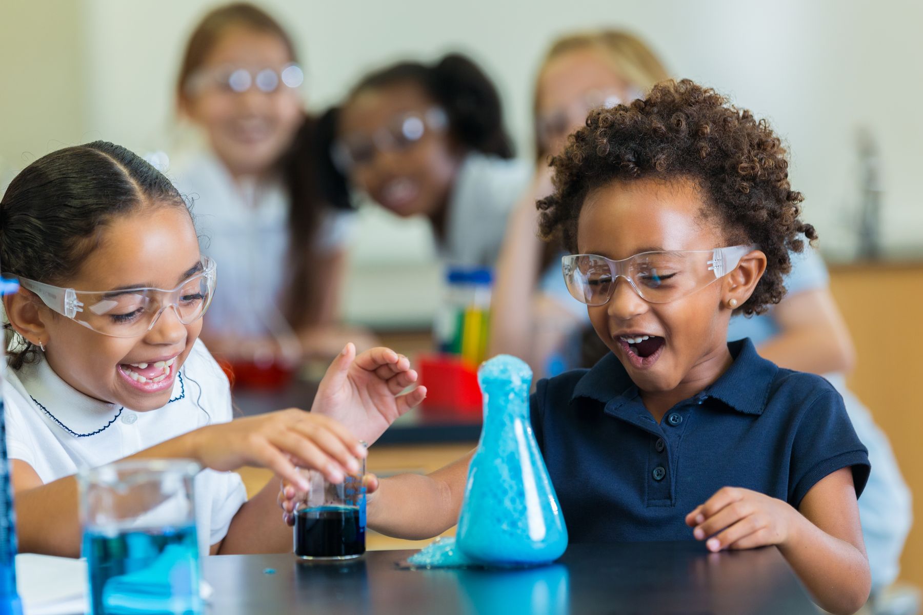 Elementary students laughing during a classroom science experiment