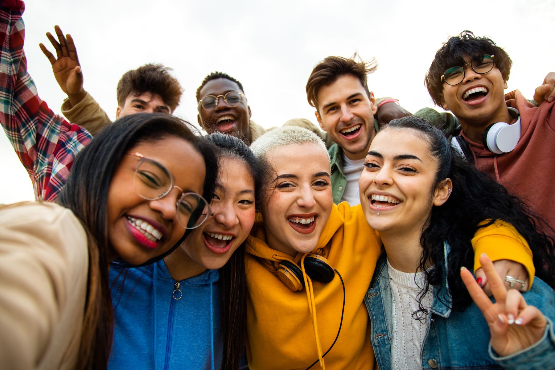 A group of college students laughing together in a selfie